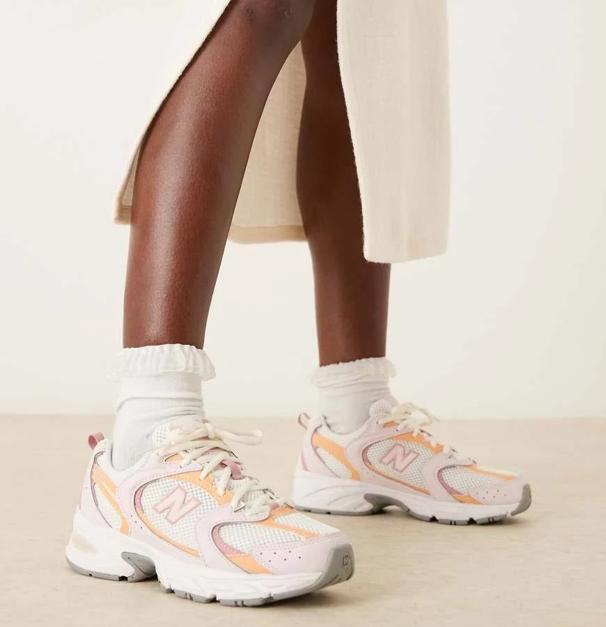 New Balance 530 sneakers in orange and pink