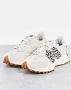 New Balance 327 sneakers in off-white with leopard print detail