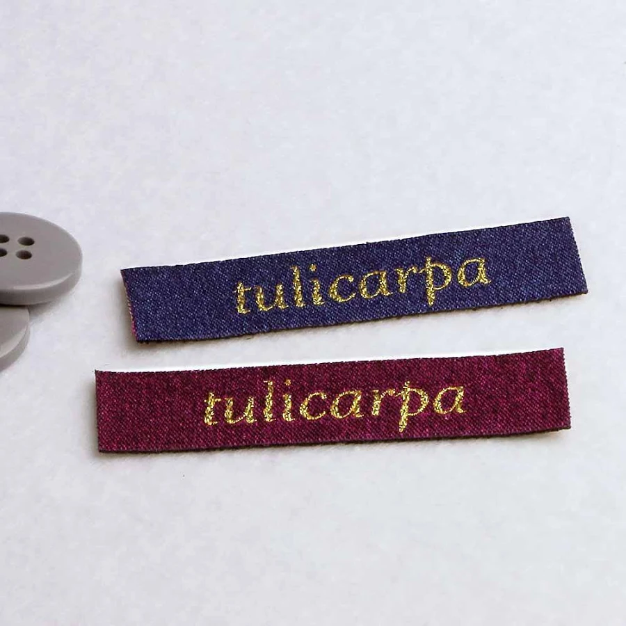 25 textile labels with glitter text, blue, 6 x 1,5 cm